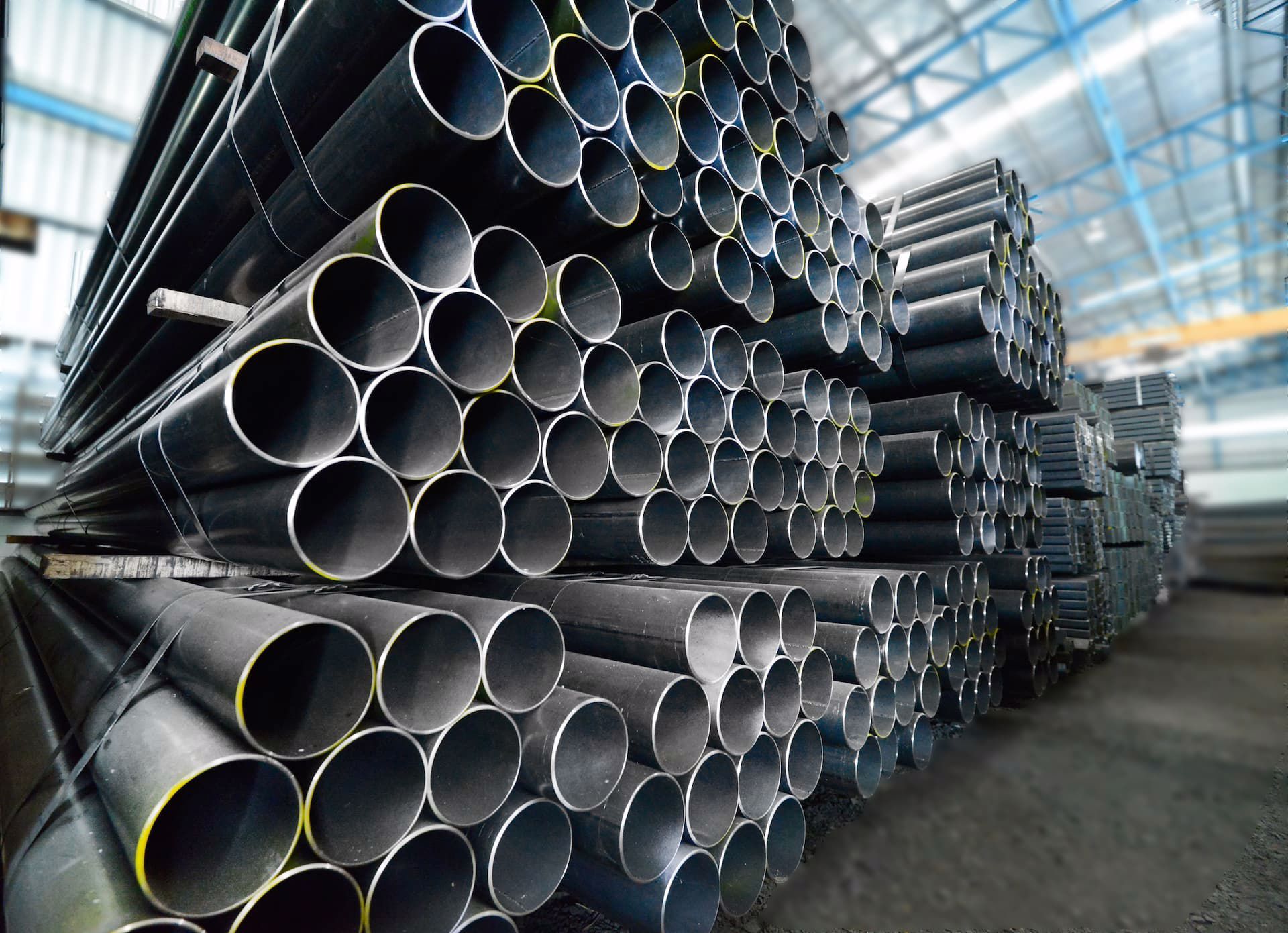 Steel pipes stacked inside an industrial warehouse